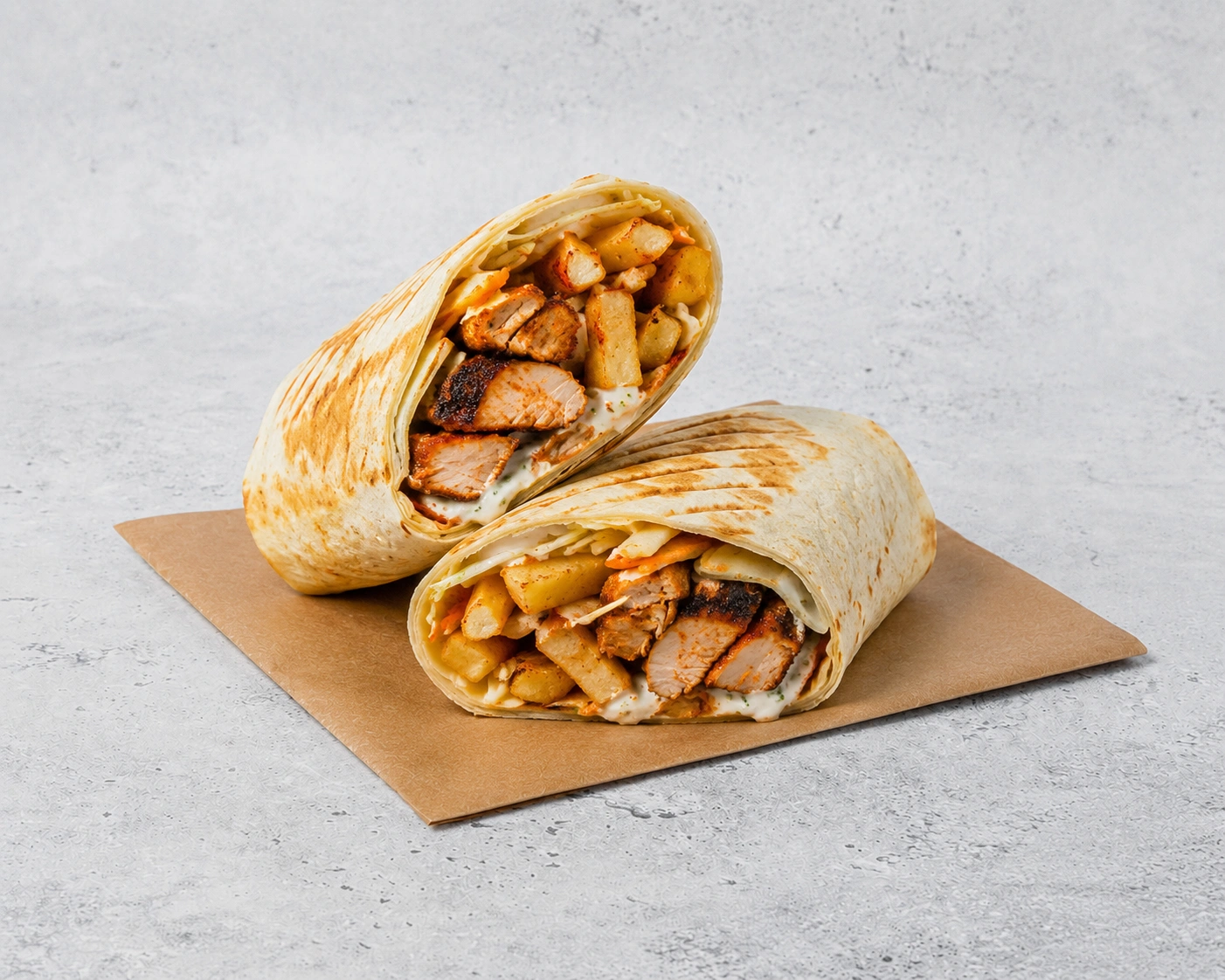 Tikka Wrap sliced in half showing char-grilled chicken tikka and crispy fries
